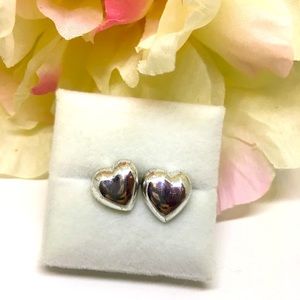 Heart shaped stud earrings silver colored